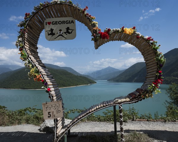 ZHINVALI, GEORGIA - AUGUST 18, 2023: Big heart next to water reservoir artificial lake Zhinvali in Georgia