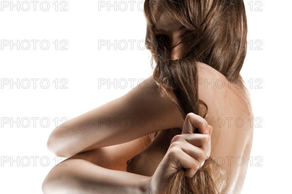 Closeup portrait of a nude young woman, isolated on white