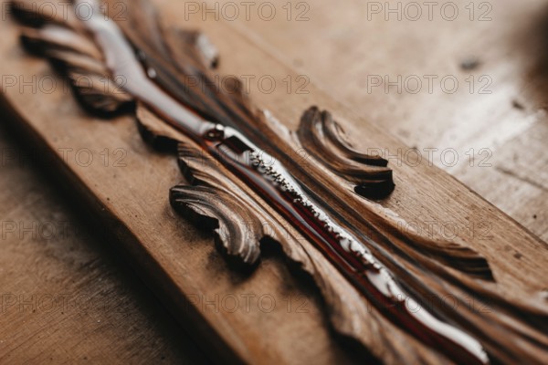 Close-up of varnish applied on carved wood, enhancing its intricate patterns