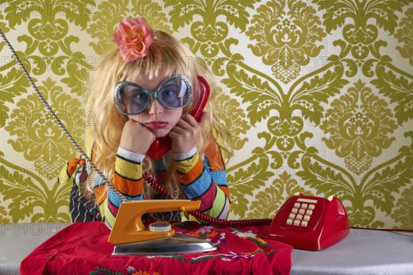 Sad housewife kid girl iron chores talking at red retro phone vintage humor