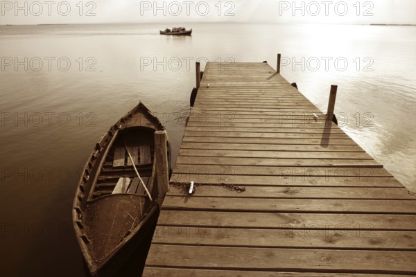 Albufera lake wetlands pier with boat in Valencia Spain
