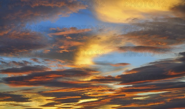 Sunset sky clouds in orange and blue background