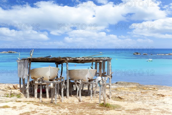 Beached boats in Formentera Els Pujols beach with turquoise water