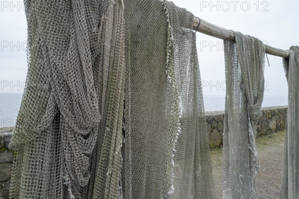 Fishing nets to dry on the road by the sea
