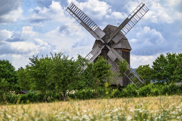 A view of a beautiful windmill in Thuringia Germany in a natural setting and an eye catcher for tourists