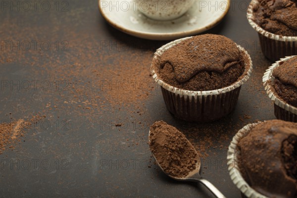 Chocolate and cocoa browny muffins with coffee cappuccino in cup angle view on brown rustic stone background, sweet homemade dark chocolate cupcakes, space for text, food photography, food photography