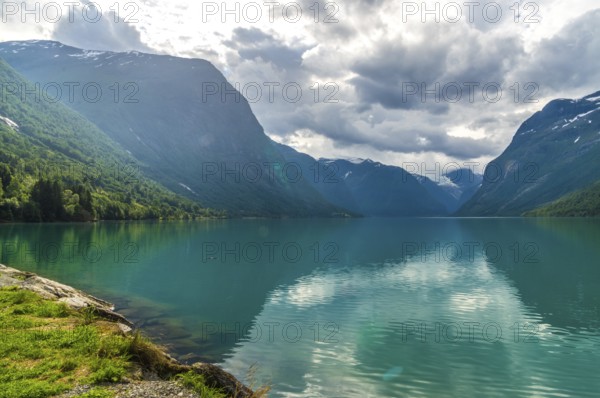 The Kjenndalsbreen is part of the Jostedalsbreen, one of the largest glaciers in Norway, and forms an impressive mountain landscape with a beautiful lake in Sande. The glacier Kjenndalsbreen with a lake in Norway is a beautiful place to travel to in summertime