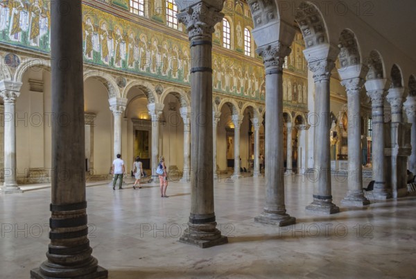 Tourists visit in the Basilica of Sant Apollinare Nuovo, Ravenna, Italy, Europe