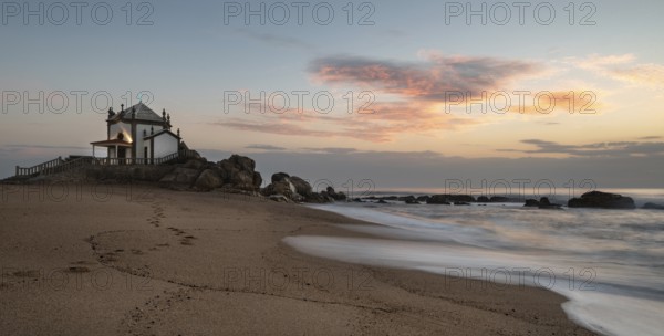 The famous and Picturesque church of Senhor da pedra south of Porto in Portugal in the Atlantic ocean during sunset