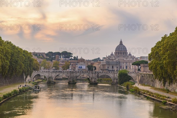 Sunset view of St. Peter's Basilica, Ponte Sant'Angelo, and Tiber River in Rome, Italy, Europe