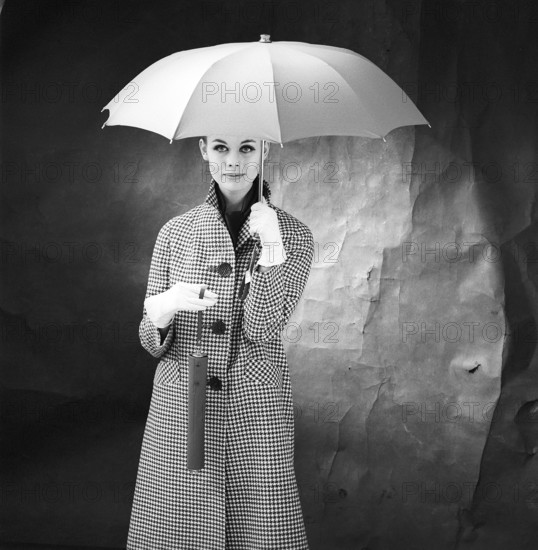 1950s woman with umbrella. A young woman is holding an umbrella. 1958. Kristoffersson ref DB75-6