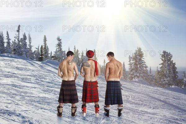 Three men peeing on the top of the mountain