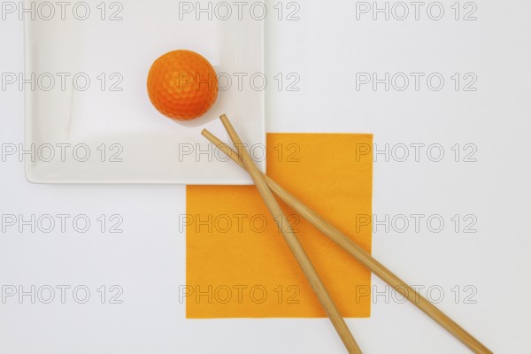 Top View Of White Empty Sushi Plates With Bamboo Chopsticks and Golf Ball. Golf Design
