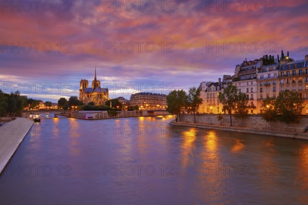 Notre Dame cathedral in Paris sunset from Seine river in France