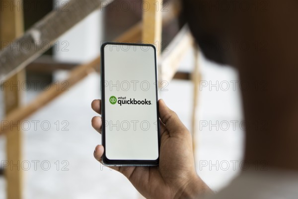 Intuit quickbooks logo is displayed on smartphone. QuickBooks is an accounting software.