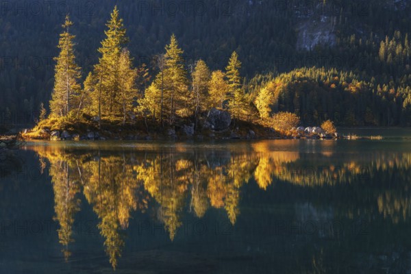 Lake Eibsee with a small island near mountain Zugspitze in south germany in fall