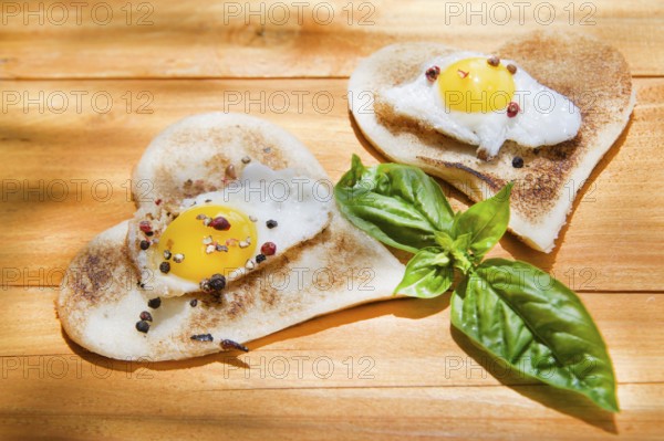 Breakfast of toast and eggs in the shape of heart