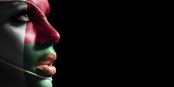 Madagascar flag painted on a face of a young woman, national flag on face