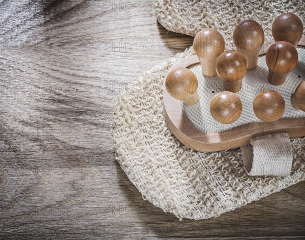 Massager peeling body scrubber on wooden board healthcare concept