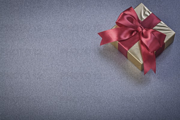 Wrapped present box on grey background holidays concept