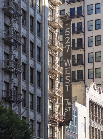 A picture of the sign and fire escape of the 527 West 7th Street building