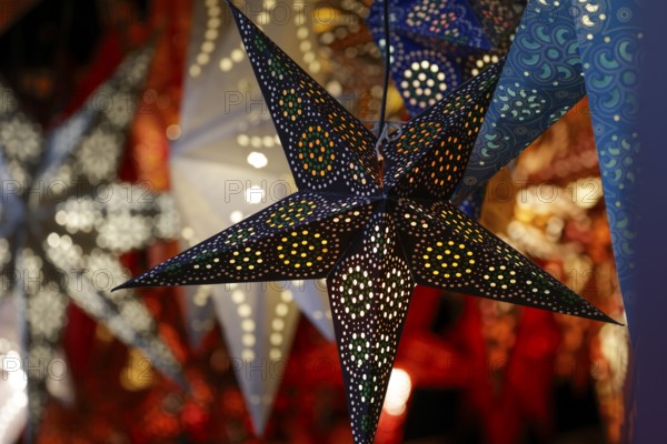 Decorative, illuminated stars with an artistic pattern create a warm, Christmassy atmosphere at a Christmas market, Cologne, North Rhine-Westphalia, Germany, Europe