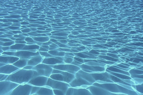 Swimming pool water sun reflection background. Ripple Water