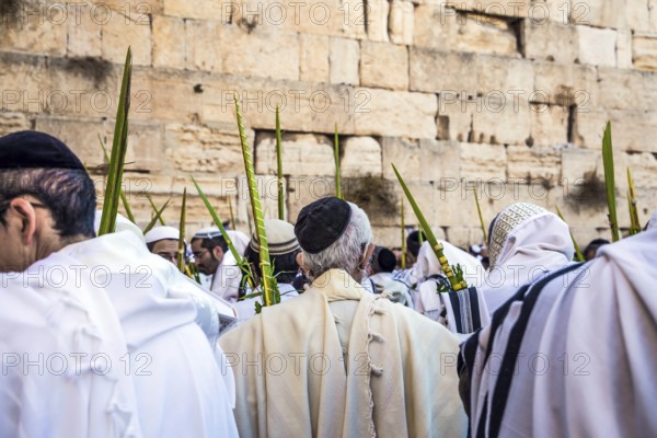 The blessing of the Cohenim in the Old City of Jerusalem. The second day of days of Passover. Jews praying at the Western Wall wrapped in white Talit. The concept of religious and photo tourism