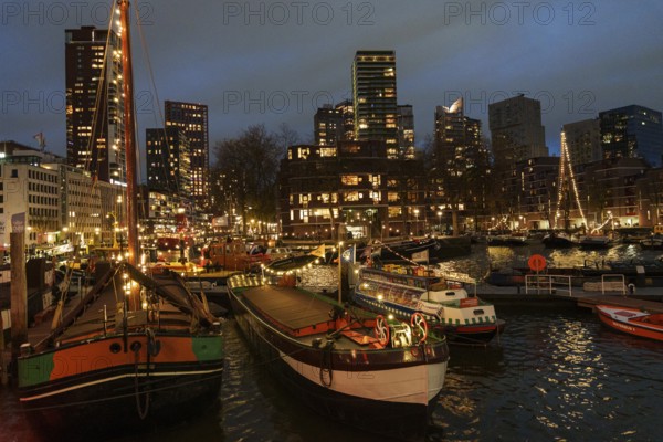 Harbour at night with illuminated buildings and boats in the water, Rotterdam, Netherlands