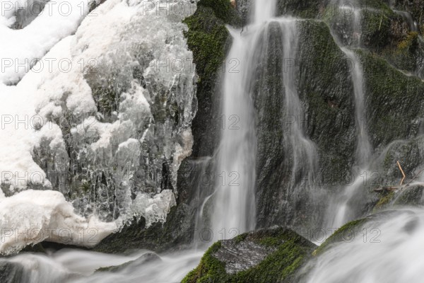 Frozen waterfall in a mountain stream in winters. Le Le Hohwald Bas-Rhin, Collectivite europeenne d'Alsace, Grand Est, France, Europe