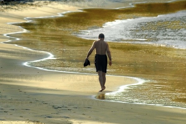 Tourist dawn walk in the beach at Kovalam kerala India