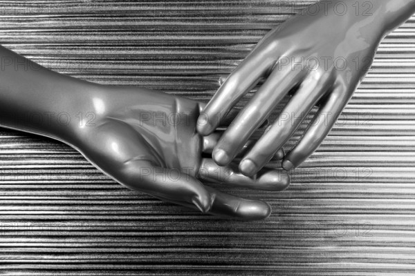 Hands together futuristic robot silver steel over gray background