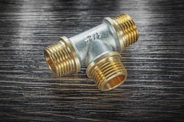 T-tube pipe connector on vintage wooden board