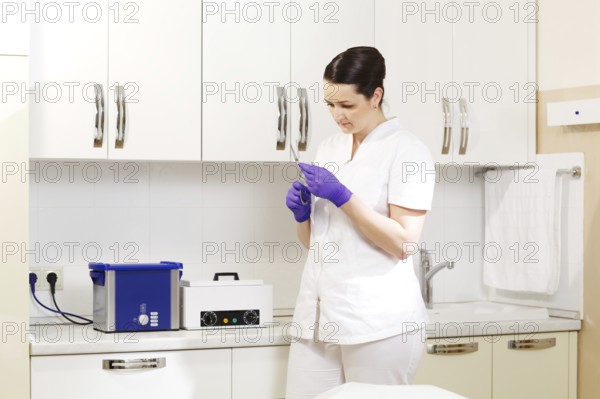 Female cosmetician in the salon preapring tools to be sterilized