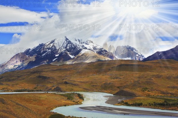 Beautiful summer morning in Patagonia.The river and the snow-capped mountains illuminated by the sun