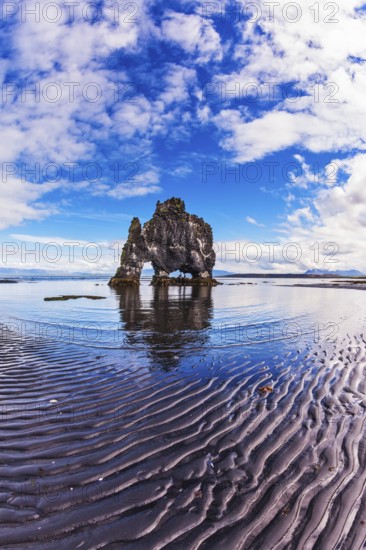 The picturesque cliff in Bay of Hoonah during low tide at sunset. Stone mammoth Iceland