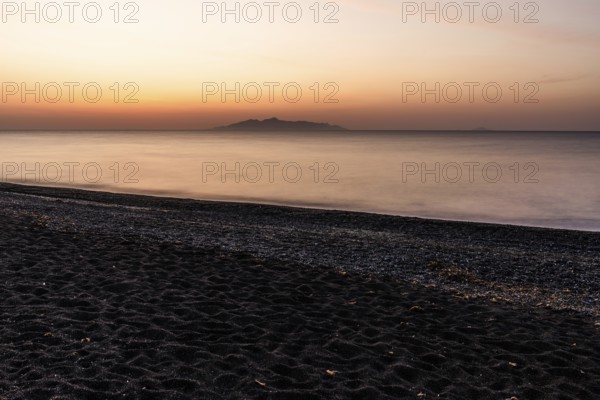 Dawn at sunrise, view from the lava beach near Kamari to the island of Anafi, long exposure, island of Santorini (Thira), Cyclades, Greek Islands, Greece, Europe