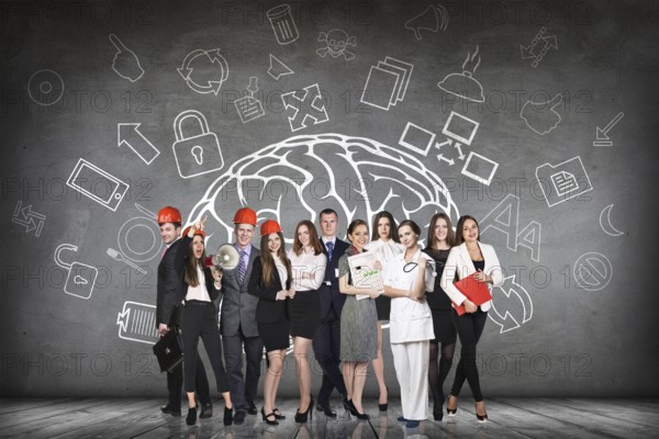 Woman stands beside big drawn brain on the gray wall