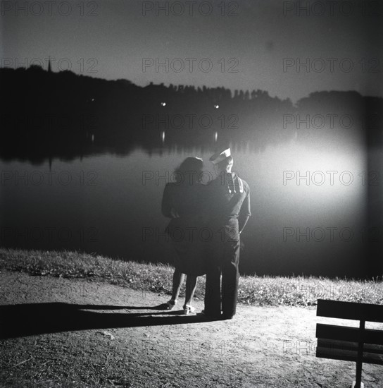 1940s sailors on shore-leave. An american sailor in Stockholm. The two american warships Houston and Perry is anchored in port and the sailor has met a swedish girl and spends the evening with her like here, enjoying the view of Stockholms waterfront. Sweden 1946 ref U146-2
