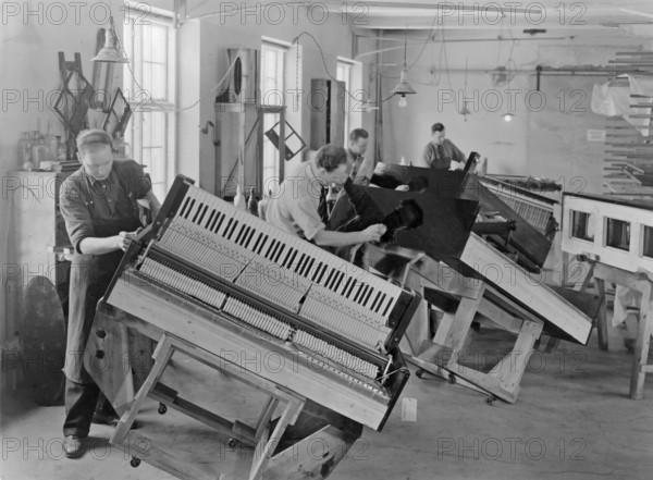 Piano manufacturer. Interior from the swedish manufacturer of pianos and grand pianos Östlind & Almquist in Arvika. Workers are seen polishing the woodwork of the piano case to make it shine