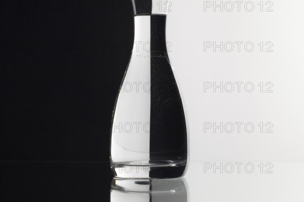 Glass of water on the black and white background on the glass table
