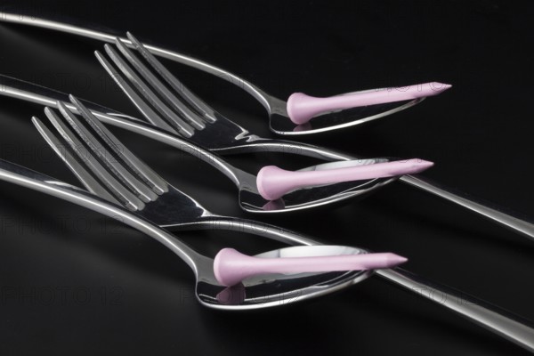 Forks and spoons on a black table