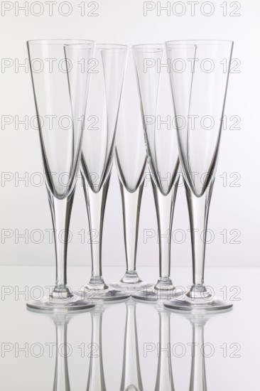 Five champagne glasses on a glass plate
