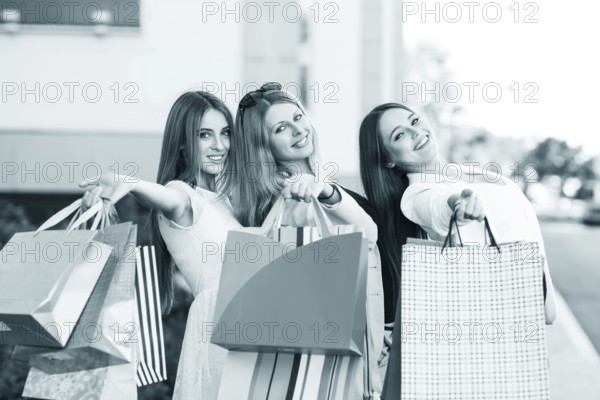 Three young women posing on a summer day in the city