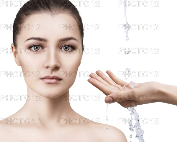 Beautiful woman face and splashes of water in hands. Cleansing and moisturizing concept