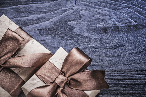 Packed gift boxes on wooden board holidays concept