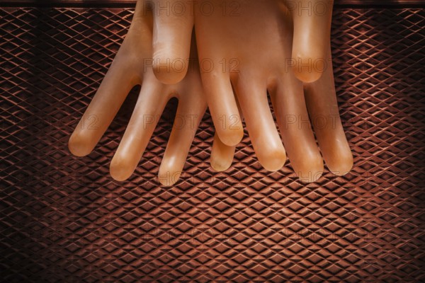 Safety insulating gloves on dielectric rubber mat
