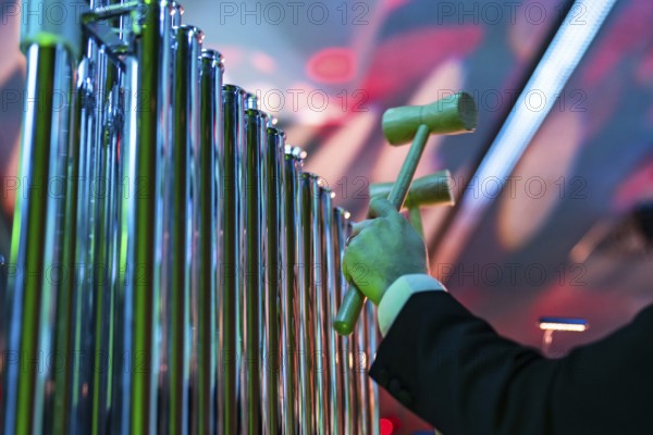 Musical instrument - tubular bells struck with a hammers during a concert