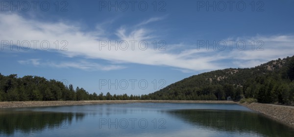 Panoramic view of dam full of water in the forest, Prodromos water reservoir Troodos mountains Cyprus