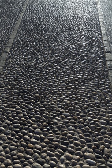 Rolling stones pavement soil texture in Altea Alicante mediterranean village of Spain